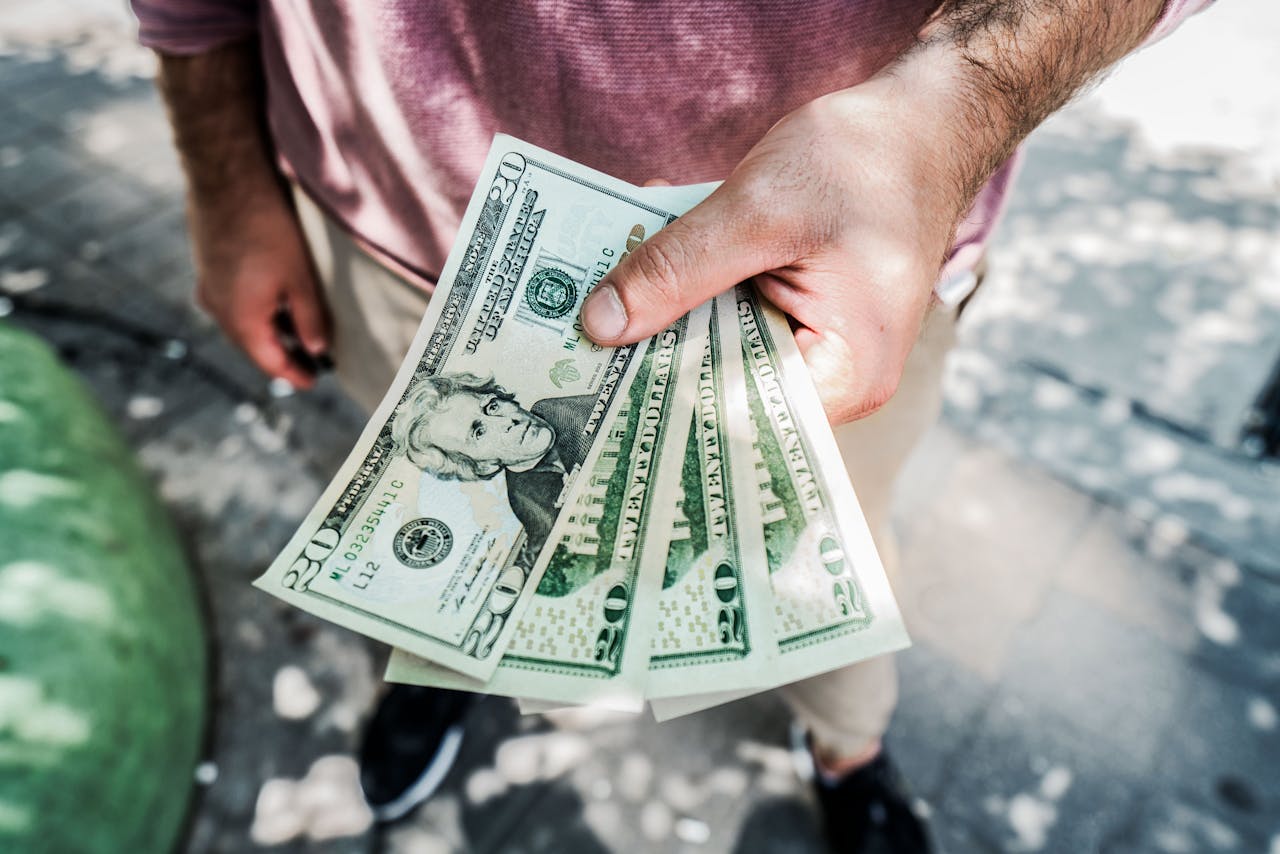 person holging money. Image by Pexels