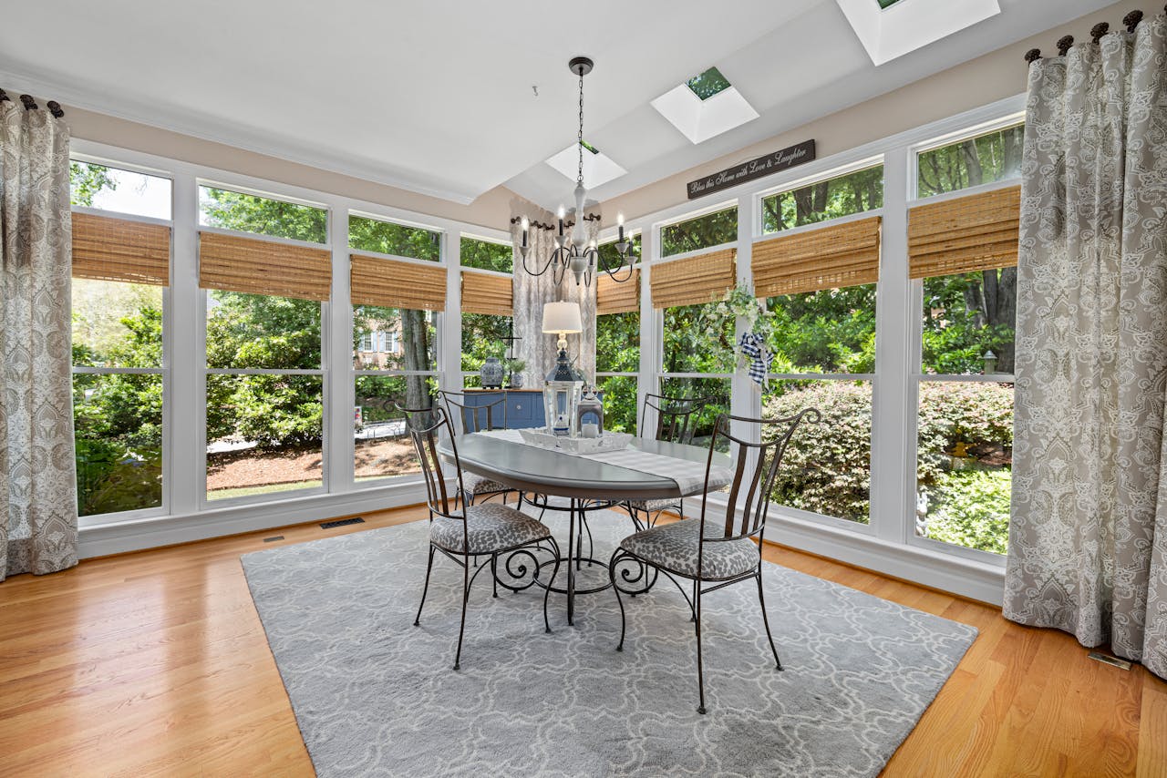 Modern living room with neutral plantation shutters and natural light streaming through windows
