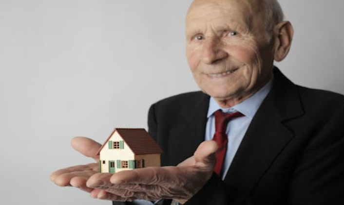 Senior holding a small ouse in their hands