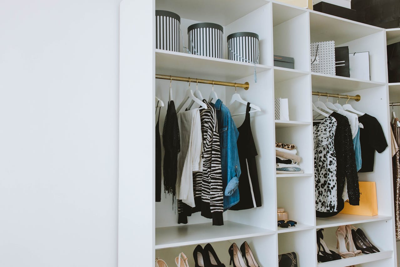 A small bedroom closet packed with clothes and boxes illustrating inadequate home storage