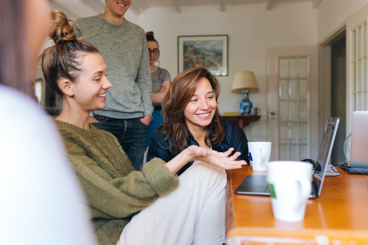 People looking at a laptop. Image by Pexels
