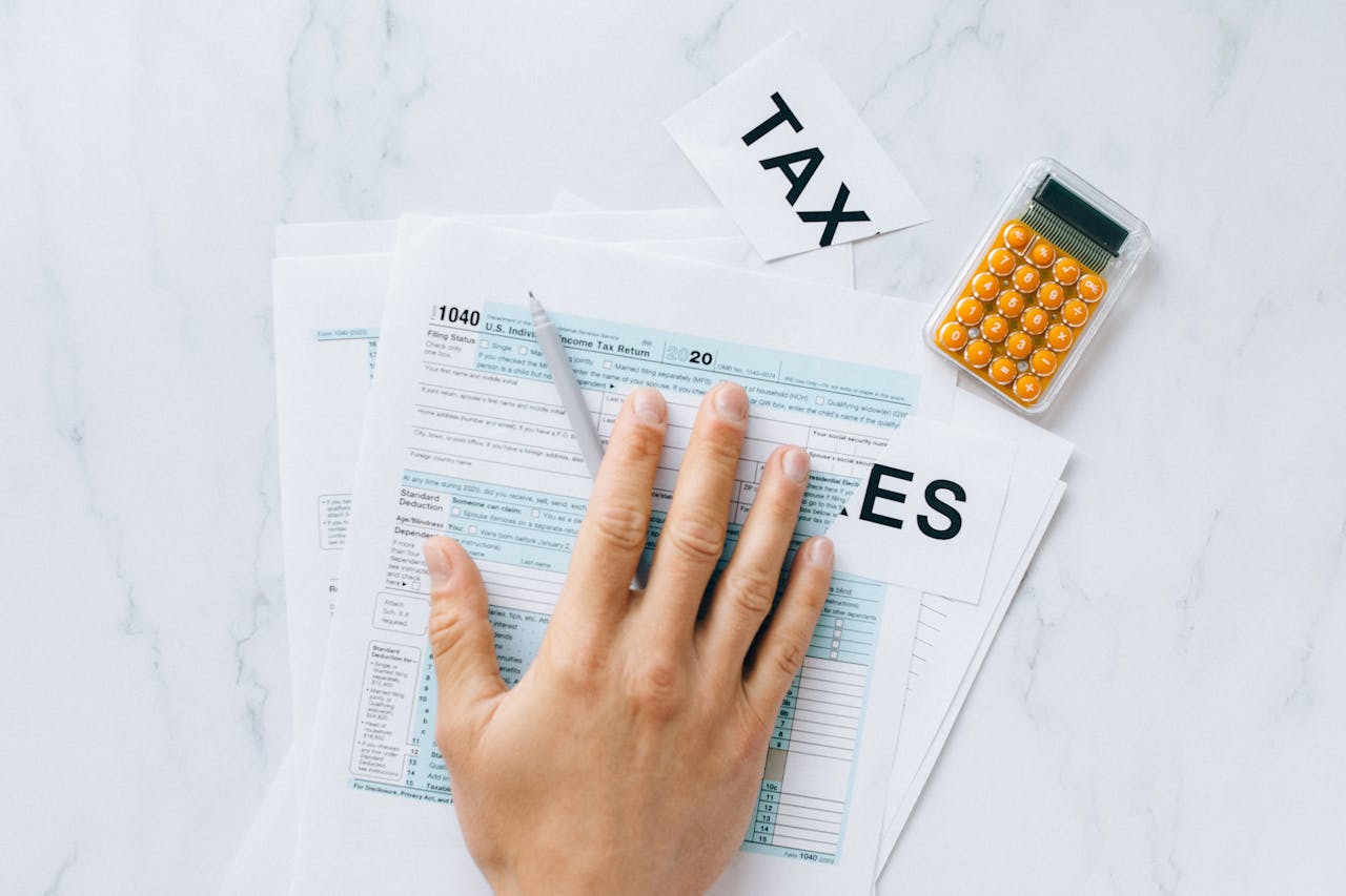 Person filing tax documents. Image by Pexels